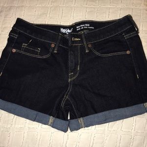 Mid-rise, dark wash jean shorts,